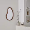 A modern living room corner with a mirror, vase with branches, and a lamp on a shelf. Anteprima dell’immagine prodotto