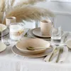A table setting with stoneware dishes, mugs, and glasses, decorated with dried pampas grass. Produktbild-Vorschau