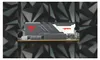A computer RAM stick with a black and gray heat spreader and a white section with red lettering, set against a geometric, abstract background. Náhľad obrázku produktu