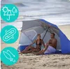 A couple relaxing on a beach under a beach umbrella/tent. Anteprima dell’immagine prodotto