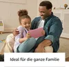 A father and daughter are sitting on the floor, looking at a tablet together. Produktbild-Vorschau