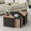 A modern living room with a couch and a set of triangular coffee tables. Produktbild-Vorschau