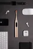 A collection of electronic devices and accessories arranged on a dark gray surface. Náhled obrázku produktu