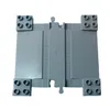 A top-down view of a light gray LEGO DUPLO train track crossing piece on a white background. Podgląd zdjęcia produktu
