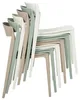A stack of modern dining chairs in various colors. Produktbild-Vorschau