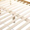 Close-up view of a wooden bed frame with slats. Produktbild-Vorschau