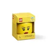 A yellow LEGO storage head is presented in its packaging against a white background. Produktbild-Vorschau