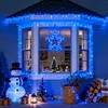 A festive outdoor Christmas decoration scene with blue lights, an inflatable snowman, Christmas trees, gifts, and firewood. Produktbild-Vorschau