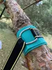 A close-up of a strap and carabiner attached to a tree branch, likely for a swing or hammock. Produktbild-Vorschau
