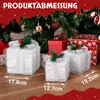 Three illuminated gift boxes are placed in front of a Christmas tree, with other wrapped gifts in the background. Anteprima dell’immagine prodotto