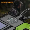 A close-up of an outdoor device with a compass, with a person in the background. Podgląd zdjęcia produktu