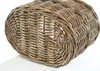 A close-up, low-angle view of the bottom of a woven rattan basket against a white background. Náhled obrázku produktu