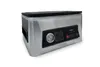 A stainless steel vacuum sealer with a black control panel and lid, shown from a three-quarter front angle against a white background. Podgląd zdjęcia produktu