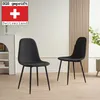 Two black dining chairs are shown in a room with a white wall and light wood paneling. A shelf unit is visible on the left. Produktbild-Vorschau
