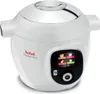 A white Tefal Cook4me+ smart multi-function pot is shown from a slightly elevated front-side angle against a white background. The pot has a digital display screen showing various icons and a circular control button below it. The lid has a shiny silver fin Podgląd zdjęcia produktu