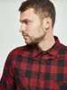Close-up of a man wearing a red and black checkered flannel shirt. Produktbild-Vorschau