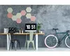 A home office setup with a desk, computer, chairs, and a bicycle. Voir les images du produit
