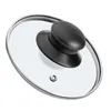 A close-up, isolated shot of a glass pot lid with a black handle. Voir les images du produit