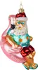 A Christmas ornament of Santa Claus riding a flamingo pool float. Voir les images du produit