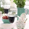 A table setting with various tableware items, drinks, and grapes. Produktbild-Vorschau