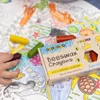 A child's hand is holding a purple crayon, with other crayons and a box of "Beeswax Crayons" on a coloring page with an ocean theme. Náhľad obrázku produktu