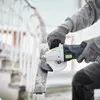A person is using an angle grinder to work on a metal railing. Produktbild-Vorschau