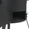 A close-up view of the side of a black outdoor cooking stove, showing an open door and the interior grate. Produktbild-Vorschau