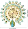 A peacock-shaped wall clock with a gold-colored face and black numbers. Náhled obrázku produktu