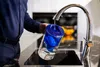 A person is filling a water filter pitcher under a kitchen faucet. Produktbild-Vorschau