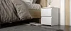 A bedside table next to a bed in a bedroom. Náhľad obrázku produktu