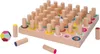A wooden educational toy with pegs and colored rings, along with some loose pegs and a geometric shape. Produktbild-Vorschau