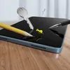 A tablet screen protector is shown with a pencil, key, and pushpins to demonstrate its durability. Anteprima dell’immagine prodotto