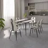 A dining room with a table and chairs set up in front of a kitchen area. Produktbild-Vorschau
