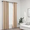 A room interior with beige curtains hanging over a window, a white sofa, and a potted plant. Produktbild-Vorschau