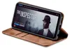 A smartphone in a brown flip case is displayed, showing a movie streaming interface on its screen. Produktbild-Vorschau