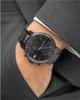 A close-up shot of a man's wrist wearing a black Tommy Hilfiger watch. Náhled obrázku produktu