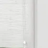 A close-up view of a white bamboo roller blind with a pull cord. Náhled obrázku produktu