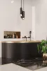 A modern bathroom with a black and gold bathtub and marble flooring. Produktbild-Vorschau