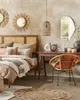 A bedroom scene with a bed, desk, and chair, decorated in a bohemian style. Náhled obrázku produktu
