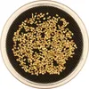 A close-up, top-down view of small gold nuggets in a clear container with a black mesh base. Produktbild-Vorschau