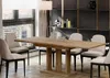 A dining room with a wooden table and chairs, a floor lamp, and shelves with decorative items. Anteprima dell’immagine prodotto