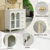 A collage of images showcasing a white bathroom vanity with gold hardware, including close-ups of the hardware and a detail of the glass door. Produktbild-Vorschau