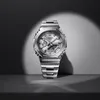 A silver G-Shock watch is displayed against a dark, spotlighted background. Voir les images du produit