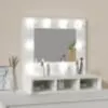 A white vanity mirror with LED lights and storage shelves below. Náhľad obrázku produktu