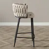 A side view of a beige bar stool with a black metal frame. Produktbild-Vorschau
