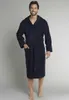A man wearing a navy blue hooded robe. Produktbild-Vorschau
