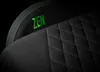 A close-up shot of a black gaming chair with green stitching and embroidered text. Produktbild-Vorschau