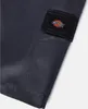 A close-up view of a pair of dark gray work shorts with a black Dickies logo patch on the side pocket. Produktbild-Vorschau