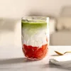 A layered drink in a glass on a table. Anteprima dell’immagine prodotto