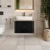 A modern bathroom with a black vanity, white sink, and wooden accents. Produktbild-Vorschau